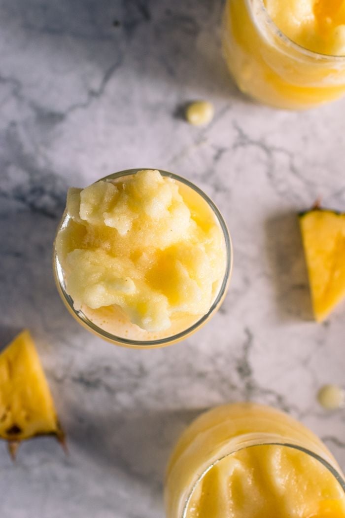 top down view of three pineapple slushies